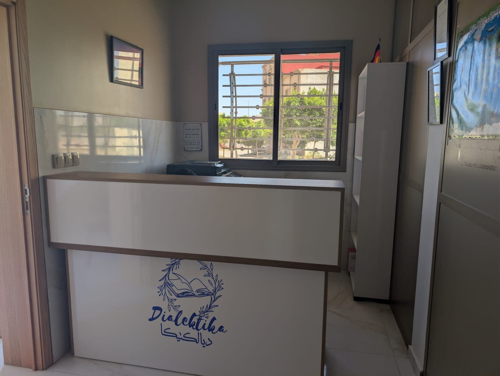 Dialektika reception area with the school logo